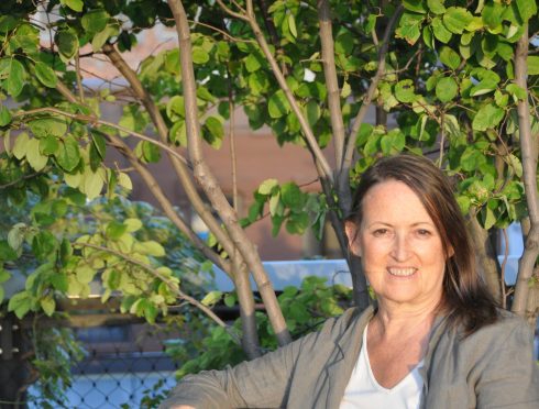 Pamela Miles of Reiki, Self Care and Medicine, Sitting outside on a bench